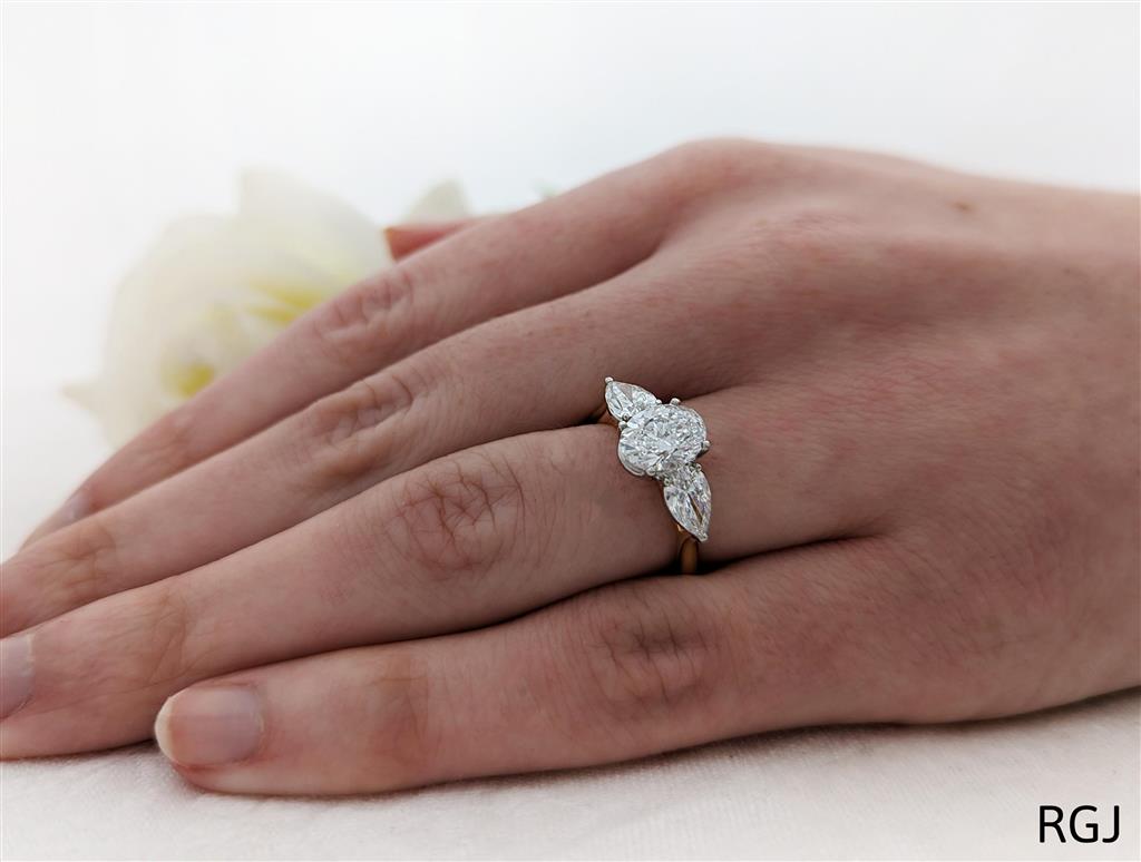 18ct Yellow Gold 1.52ct Oval And 1.01ct Pear Cut Laboratory Grown Diamond Three Stone Engagement Ring