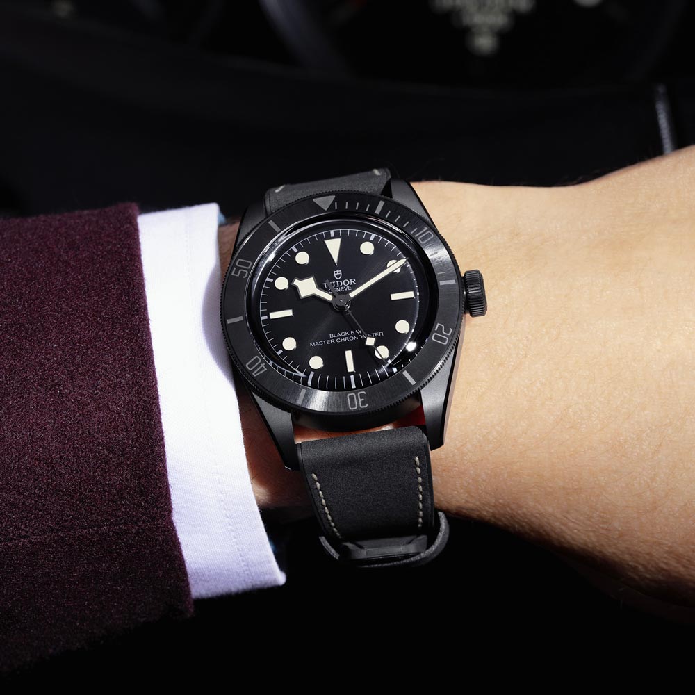 tudor black bay ceramic 41mm black dial ceramic on black leather strap automatic watch lifestyle image