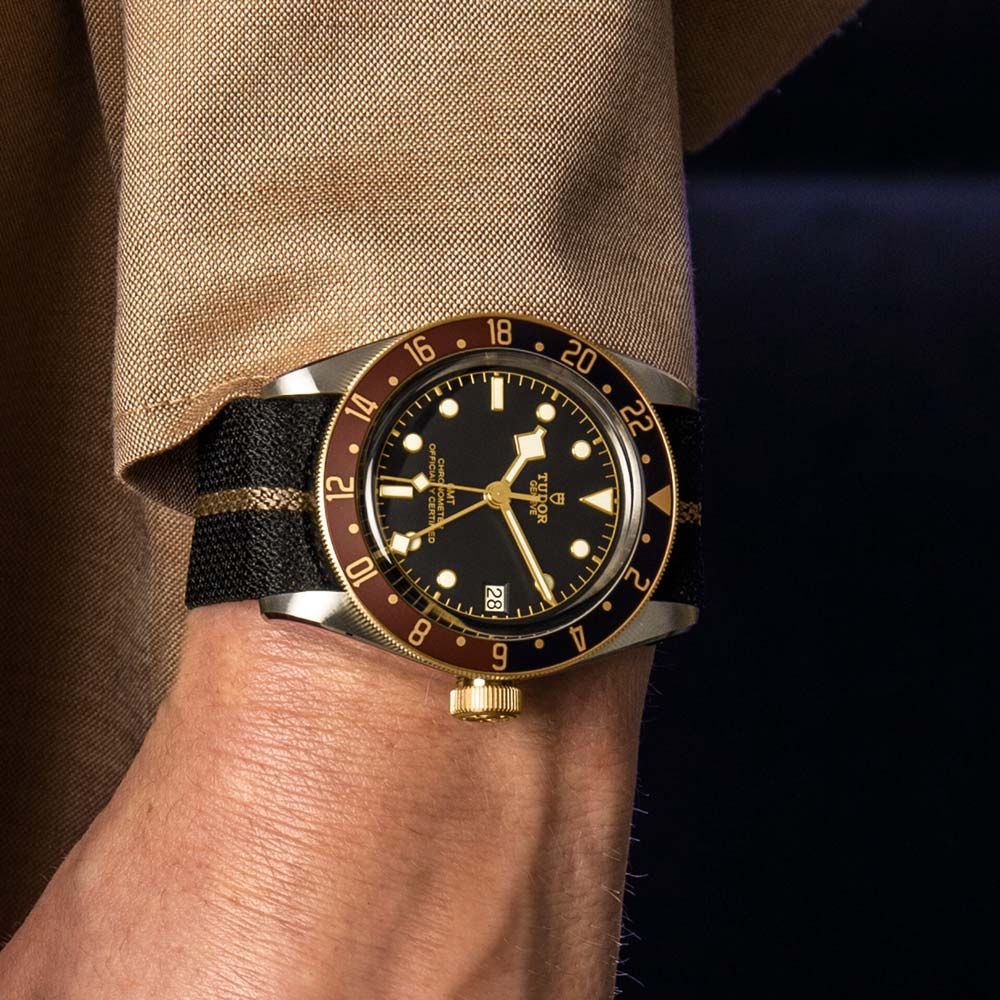 tudor black bay gmt s&g 41mm black dial gold and steel on fabric strap automatic watch lifestyle image