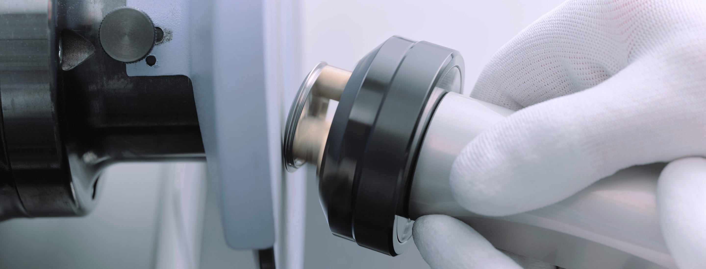 Close‑up image showing a domed bezel undergoing polishing as part of the watch servicing process, with tools visible