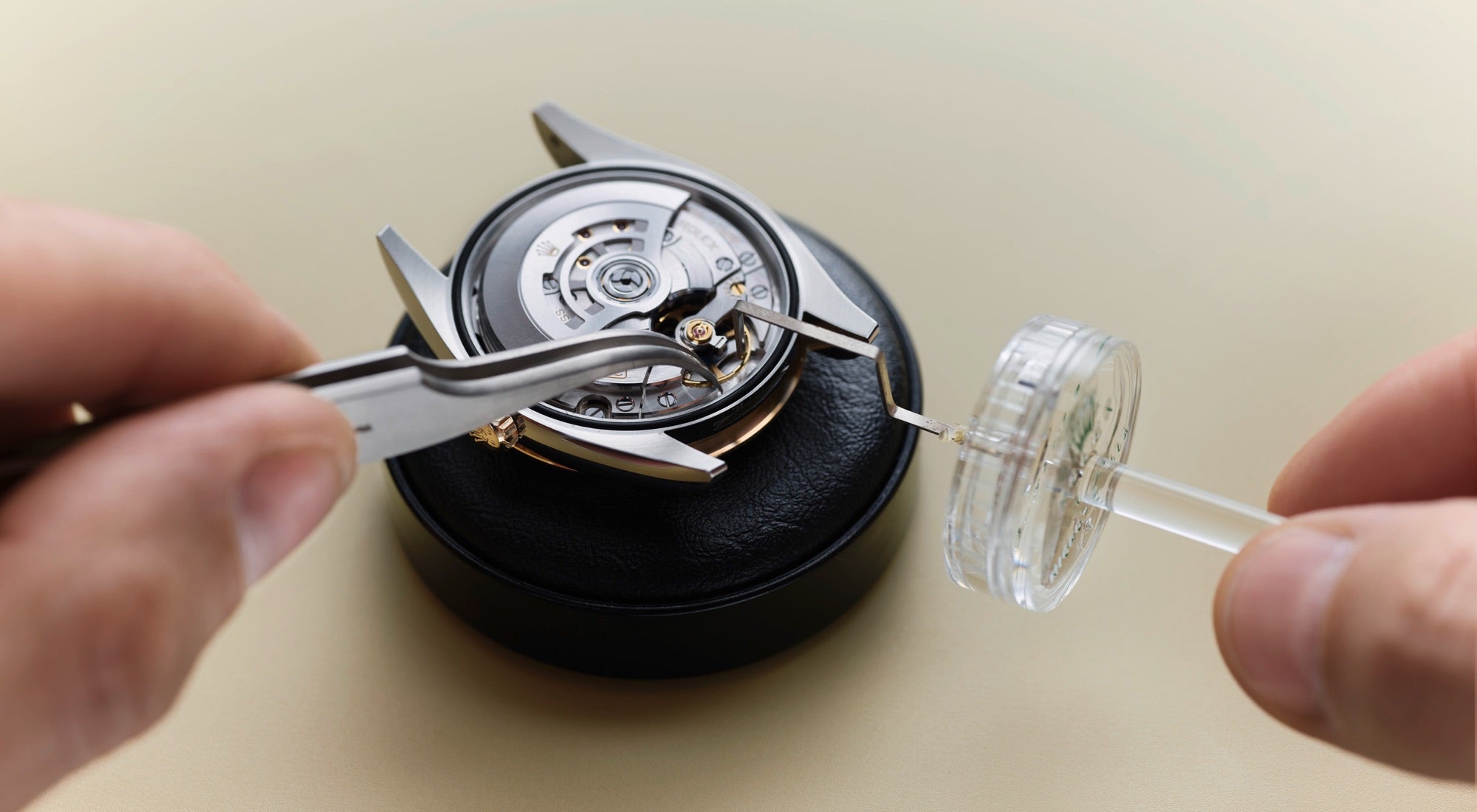 Close‑up image of a watchmaker carefully working on a watch movement