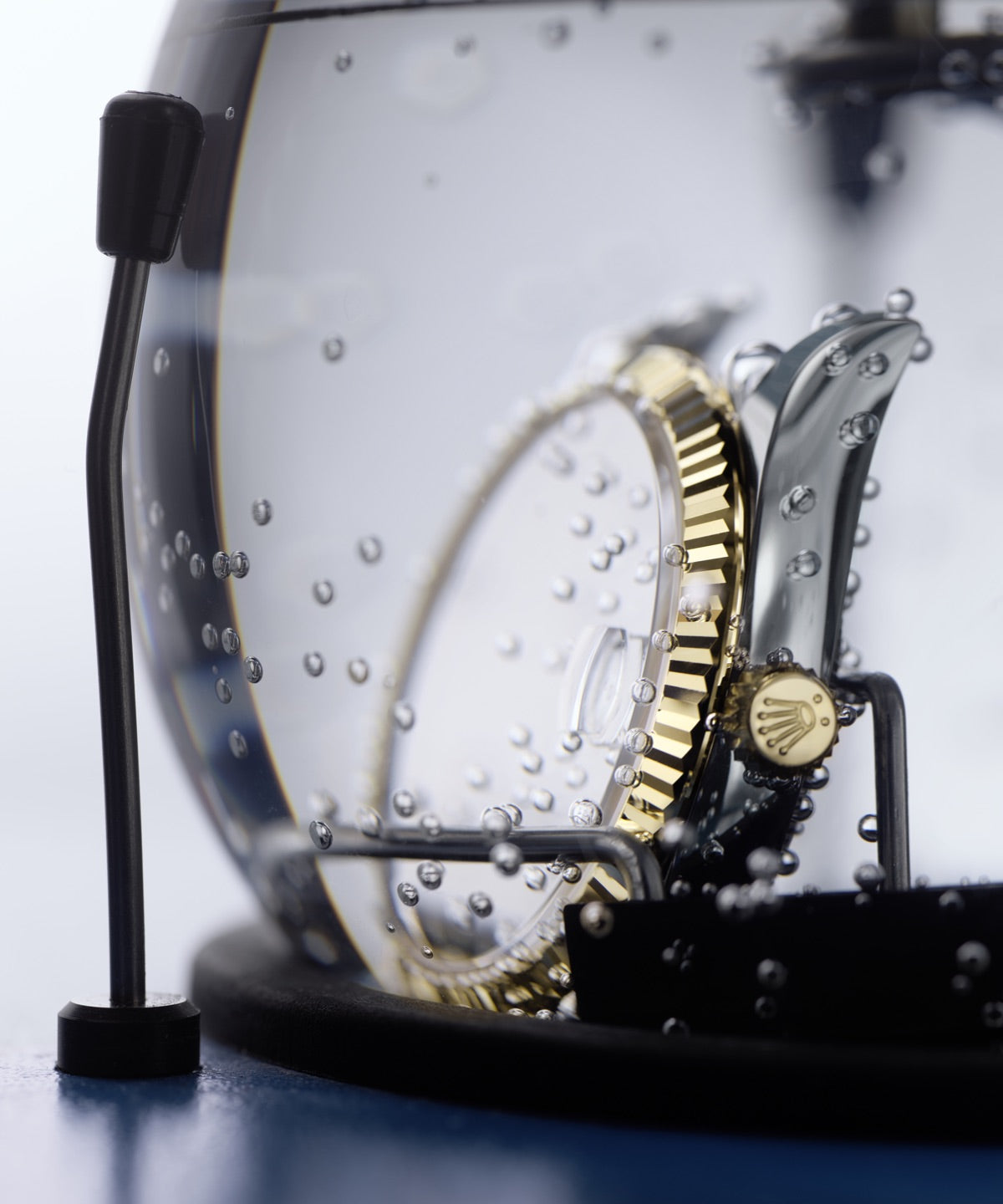 Close‑up of a Rolex watch fully submerged in water as part of its waterproofness testing process