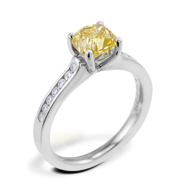 The Waterlily Platinum Cushion Cut Yellow Diamond Solitaire Engagement Ring With Diamond Set Shoulders