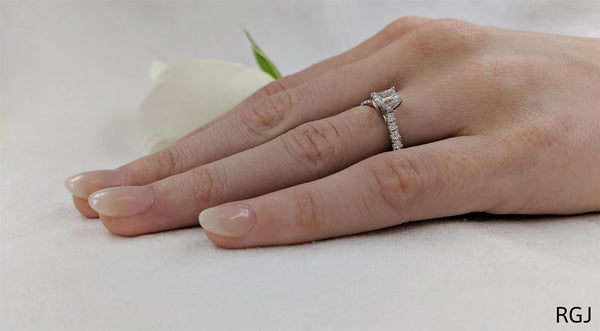 the skye classic platinum emerald cut diamond solitaire engagement ring with diamond set shoulders model shot