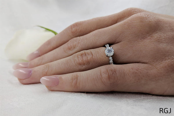 the skye classic platinum round brilliant cut diamond solitaire engagement ring with diamond set shoulders model shot