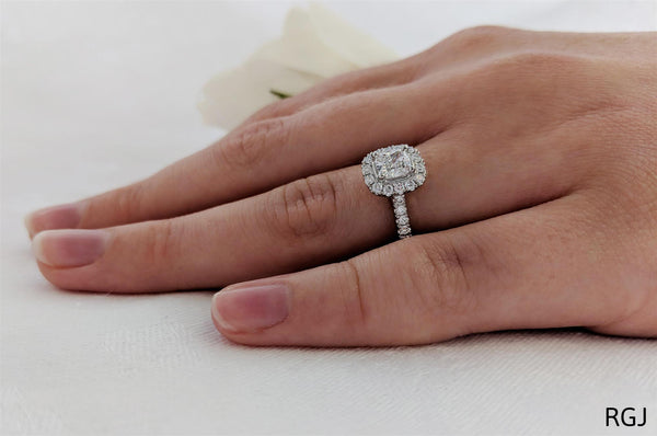 the skye platinum cushion cut diamond engagement ring with diamond halo and diamond set shoulders model shot
