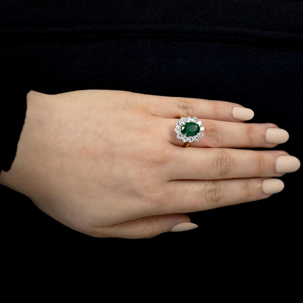18ct Yellow And White Gold 3.33ct Oval Cut Emerald And 1.74ct Round Brilliant Cut Diamond Cluster Ring