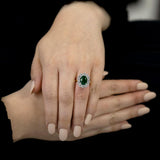 18ct yellow and white gold 3.33ct oval cut emerald and 1.74ct round brilliant cut diamond cluster ring model shot