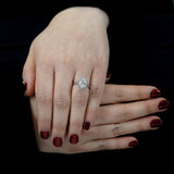 the oval cut platinum lab grown diamond engagement ring with lab grown round brilliant cut diamond halo model shot