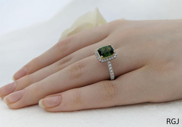 the faroe platinum and 18ct yellow gold 1.51ct cushion cut green tourmaline ring with 0.39ct round brilliant cut diamond halo and set shoulders model shot