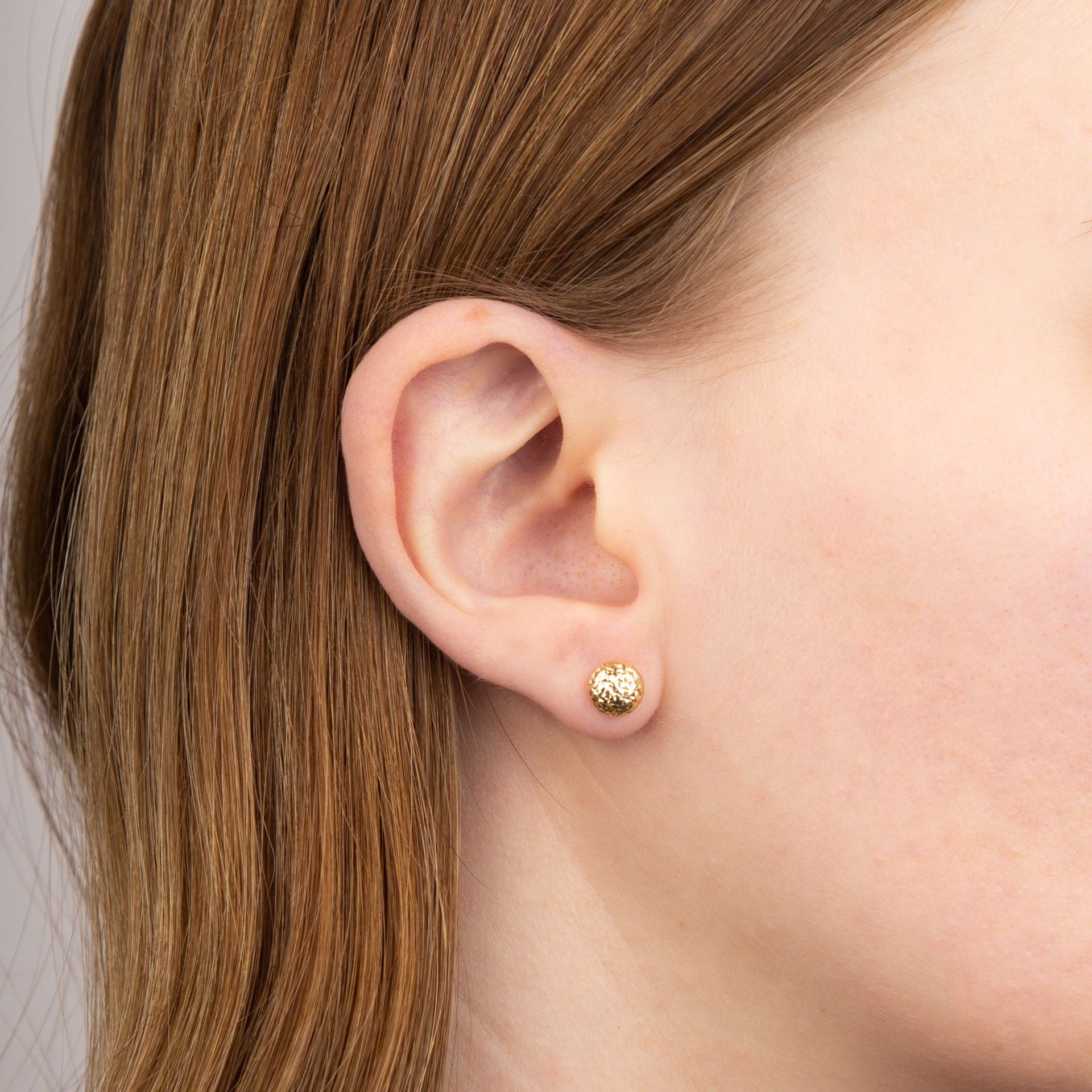 9ct yellow gold textured ball stud earrings model shot
