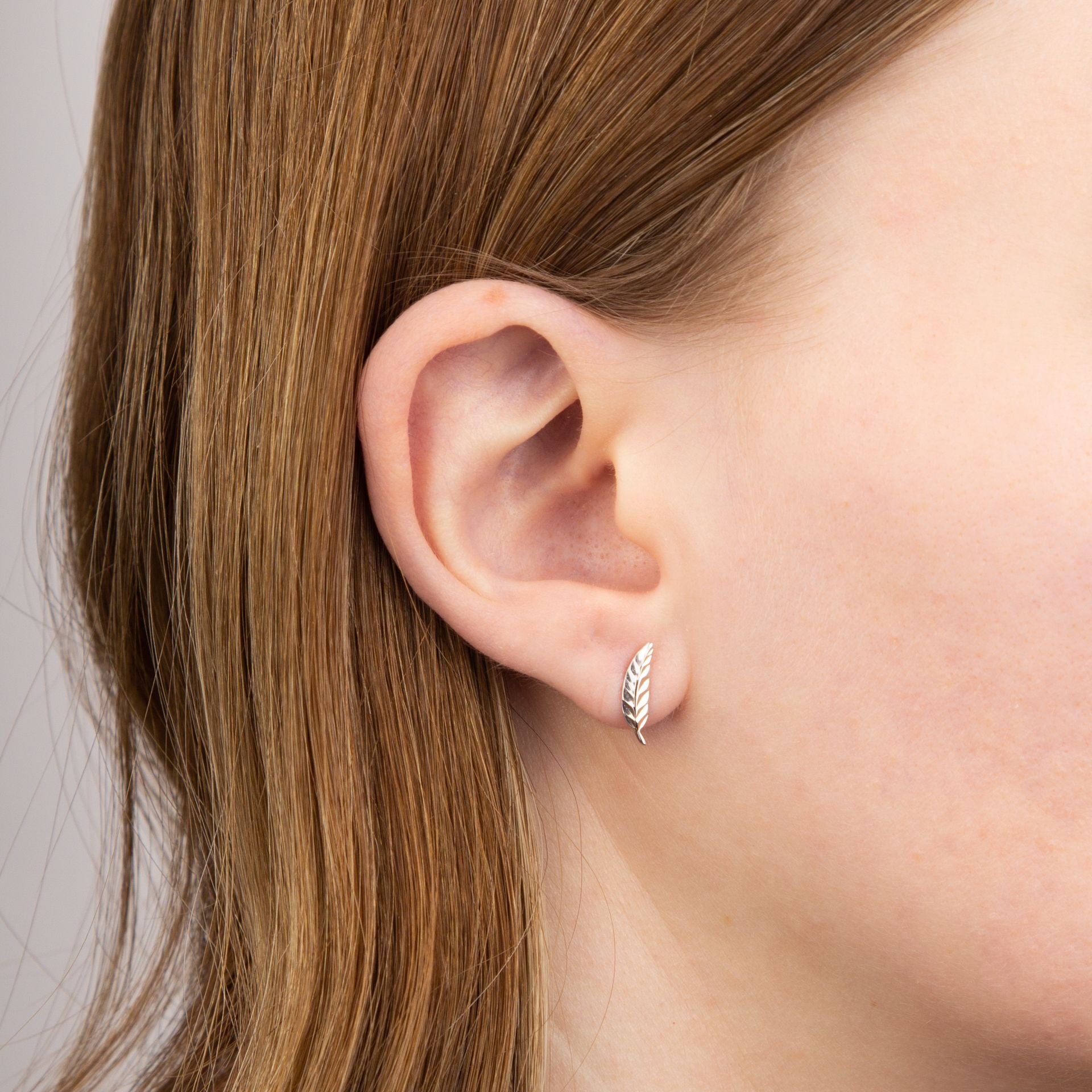 9ct white gold feather stud earrings model shot