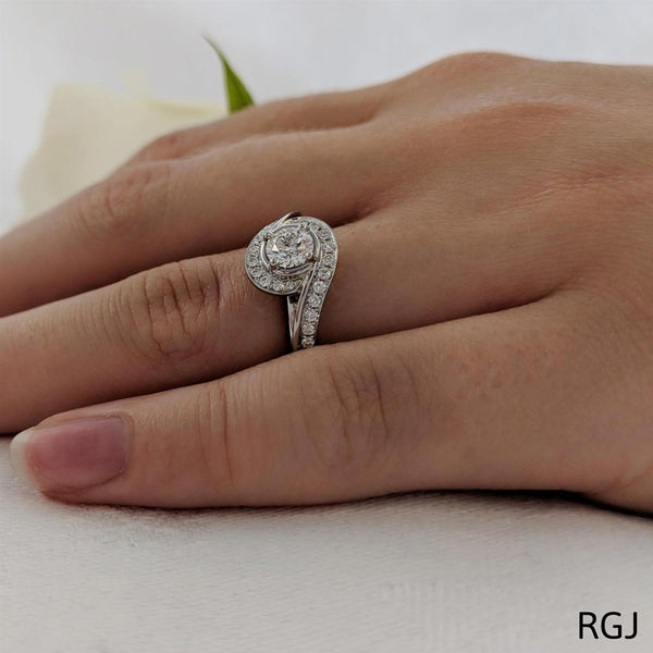 The Tiree Platinum Round Brilliant Cut Diamond Swirl Engagement Ring With Diamond Halo And Diamond Set Shoulders