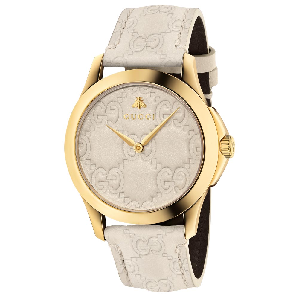 gucci g-timeless 38mm signature white dial gold PVD stainless steel watch on white leather strap front facing upright image